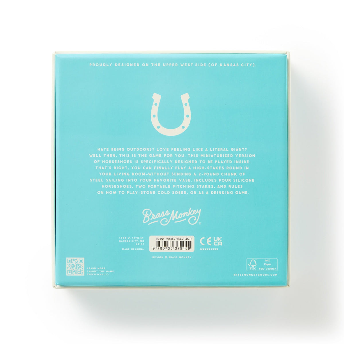 The back of the turquoise Giddy Up Tabletop Horseshoes Game box displays a horseshoe graphic at the top, fun gameplay details, and Brass Monkey branding with company info and icons at the bottom.