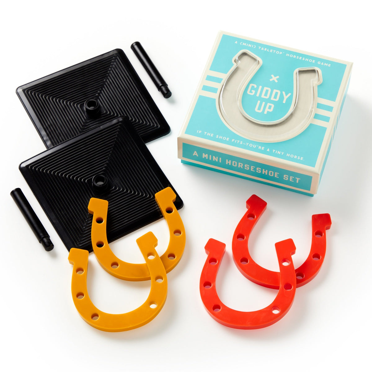 The Brass Monkey Giddy Up Tabletop Horseshoes Game includes two black bases, two black pegs, orange and red rubber horseshoes, and comes in a blue box—perfect for party fun.
