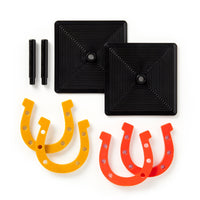 The Brass Monkey Giddy Up Tabletop Horseshoes Game includes two black square bases, two black pegs, and four rubber horseshoes (two yellow, two orange)—ideal for indoor parties.