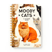 The Brass Monkey Moody Cats Sticker Book features a spiral binding, expressive cat illustrations on the cover, and includes assorted Moody Cats stickers and oversized stickers with “If they fits, they sticks” text—ideal for decorating with cat attitude.