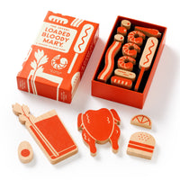 Brass Monkeys (Over) Loaded Bloody Mary Balance Game features painted wooden pieces shaped like a Bloody Mary, garnishes, burger, egg, shrimp, and more—all displayed with its vibrant game box.