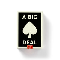 A black box for Brass Monkey’s A Big Deal Giant Playing Cards features “A BIG DEAL” in white and a large white spade symbol at the center, with a vintage design accentuated by a small red rectangle near the bottom.