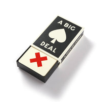 A black and white box labeled A Big Deal with a spade symbol from Brass Monkey contains A Big Deal Giant Playing Cards; the top oversized card features a large red X in a vintage-inspired design.