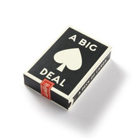 A black-and-white box of Brass Monkeys A Big Deal Giant Playing Cards features a large spade, the words “A BIG DEAL” on the lid, a red seal on one corner, and “A DECK OF CARDS” on the side in a vintage-inspired design.
