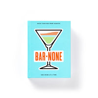 A vibrant blue Bar None Drink Journal by Brass Monkey features a martini glass and bold orange title. The cover invites you to build your bar from scratch with cocktail recipes and inspiration.