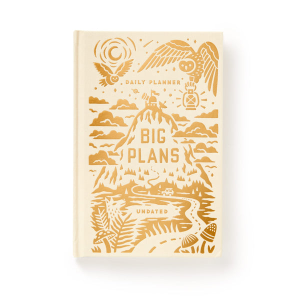 The Big Plans Undated Standard Planner by Brass Monkey is a vintage-inspired cream hardcover with gold mountain, plant, cloud, and bird illustrations. The cover says Daily Planner, Big Plans, and Undated.
