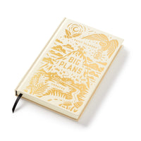 The Big Plans Undated Standard Planner by Brass Monkey is a cream hardcover daily planner with gold vintage-style mountain, sun, and nature designs. The cover features “Big Plans” text and includes a black ribbon bookmark.