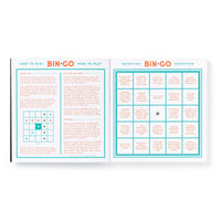 The Bin-go Endure A Wedding Bingo Book by Brass Monkey features wedding instructions on the left and a reception-themed people-watching bingo card on the right, highlighted with turquoise and orange for a playful touch.
