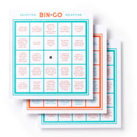 Three colorful Bin-go Endure A Wedding Bingo Books by Brass Monkey are stacked, each filled with funny wedding event scenarios—such as someone cries or the cake is cut—making it the perfect people-watching bingo game for weddings.