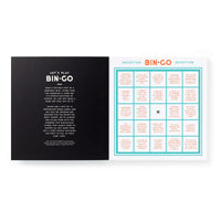 A Brass Monkey Bin-go Endure A Wedding Bingo Book lies open: the left page introduces the game in white text on black, while the right shows a colorful “Reception BIN-GO” card filled with fun wedding bingo prompts.
