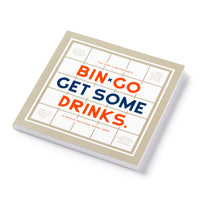 The Brass Monkey Bin-go Get Some Drinks Bingo Book is a square, people-watching game with a beige border and bold orange and blue letters on white, inspired by classic bar and restaurant games.