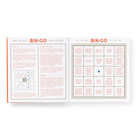 The Brass Monkey Bin-go Get Some Drinks Bingo Book opens to show “How to Play Bingo” instructions on the left and a 5x5 “Bar Bingo” game card on the right, filled with bar games and people-watching scenarios.