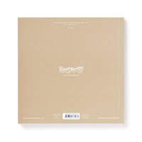 A light brown square package for Brass Monkey’s Bin-go Get Some Drinks Bingo Book features the logo and slogan It’s Our Name.© in white at the center, plus smaller white text and a barcode near the bottom—perfect for bar or restaurant games.