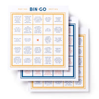 Three overlapping Brass Monkey Bin-go To A Dumb Meeting Bingo Book cards, each with a 5x5 grid of common office scenarios like “A lunch is discussed,” “Boss interrupts,” and “Technical difficulties.”.