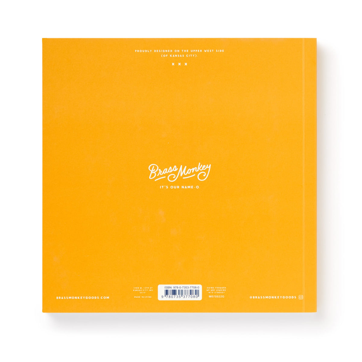 A bright orange square book cover featuring Bin-go To A Dumb Meeting Bingo Book by Brass Monkey in white script—ideal for office life fans, with small text, a barcode at the bottom, and social media handles in the corners.