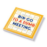 The Brass Monkey Bin-go To A Dumb Meeting Bingo Book is a square, yellow-covered book with a bingo card design and colorful text—a hilarious game that adds fun to any office meeting.