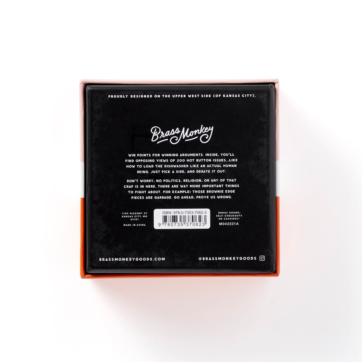 The image shows the back of a square black box with Brass Monkey at the top and details about the Debatable Game Set—a social game with debate cards on hot button topics—plus website, social media handle, and barcode underneath.