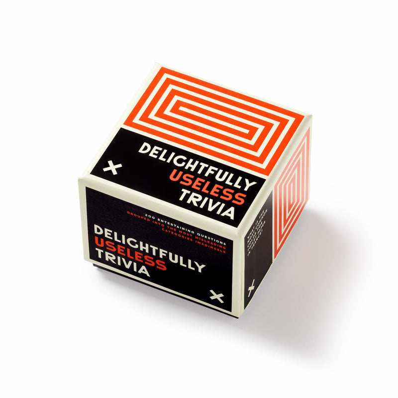 Brass Monkey’s Delightfully Useless Trivia is a cube-shaped box with bold black, white, and orange geometric designs, playful typography, and twisty categories for a fun spin on useless knowledge.
