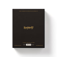 The back of a black rectangular box features gold text reading Brass Monkey in the center, with smaller gold and white details—ideal for fans of the Employee Of The Month 300 Piece Apartment Puzzle by Brass Monkey—set against a white background.