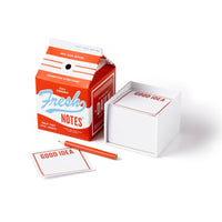 The Brass Monkey Fresh Ideas Milk Carton Note Set features square, tear-off GOOD IDEA sheets beside an open, milk carton-shaped Fresh Notes box and a red pencil.
