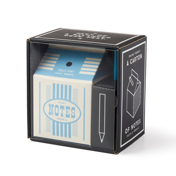 The Grade A Notes Milk Carton Note Set by Brass Monkey is a cube-shaped notepad with tear-off sheets, packaged in a black box featuring white text and a pencil illustration.