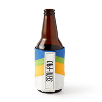Keep your drink cold with the Brass Monkey Hold My Beer Puffyvest Coozie Set—a brown glass bottle in a vibrant koozie featuring blue, green, yellow, and white diagonal stripes and a SEMI-PRO label. Perfect for vintage coozie lovers!.