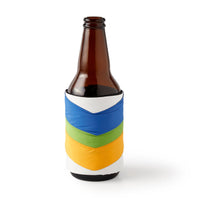 The Hold My Beer Puffyvest Coozie Set by Brass Monkey features a brown glass bottle in a colorful chevron-striped, fabric sleeve for stylishly cool insulated drinks against a plain white background.