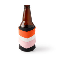 The Brass Monkey Hold My Beer Puffyvest Coozie Set features a brown glass bottle in a fabric sleeve with orange, white, pink, and black chevron stripes—adding retro flair to your insulated drink against a plain white background.