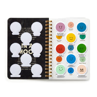 The Brass Monkey In A Mood Sticker Book features an open spiral-bound page with blank sticker shapes on the left and colorful round emoticon stickers on the right, each with unique faces, labels, and moods to express a range of emotions.