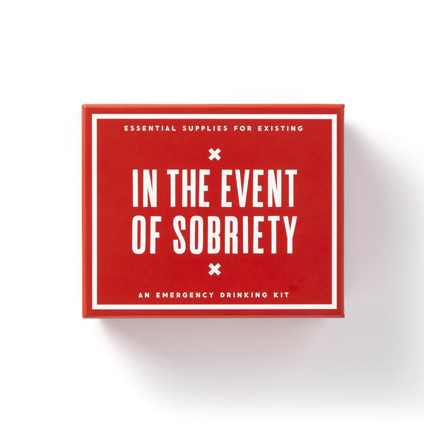A red box with white text reads: In The Event Of Sobriety. This Brass Monkey emergency drinking kit includes essentials for surviving sobriety, plus a mini cocktail recipe book. The box is displayed on a white background.