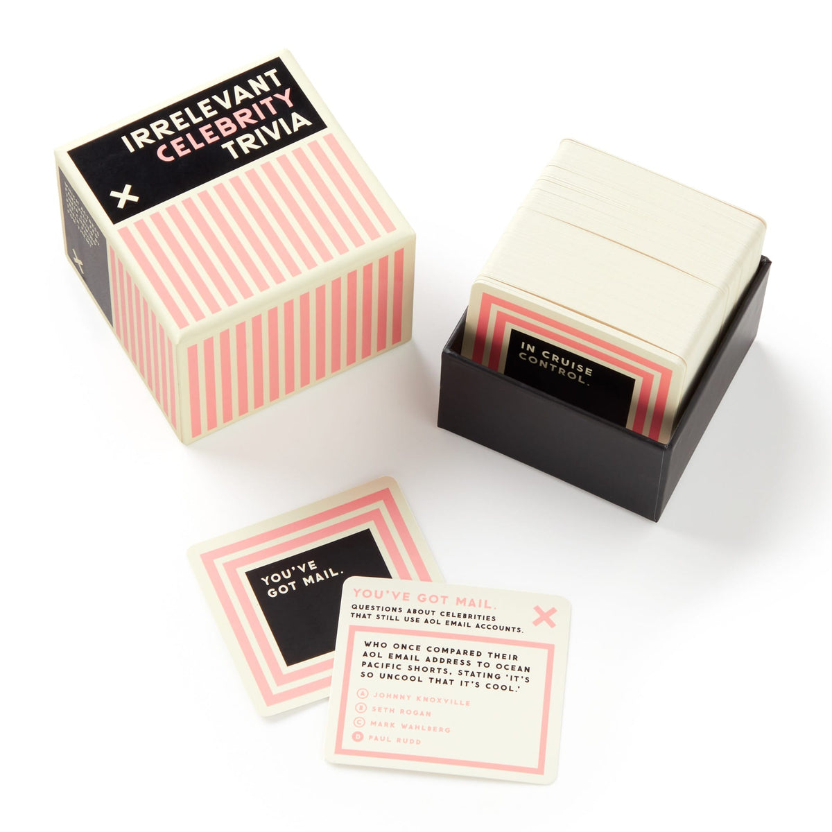 Irrelevant Celebrity Trivia by Brass Monkey is a boxed celebrity trivia game with cards featuring useless celebrity facts. The box and cards have a pink, black, and cream striped design.