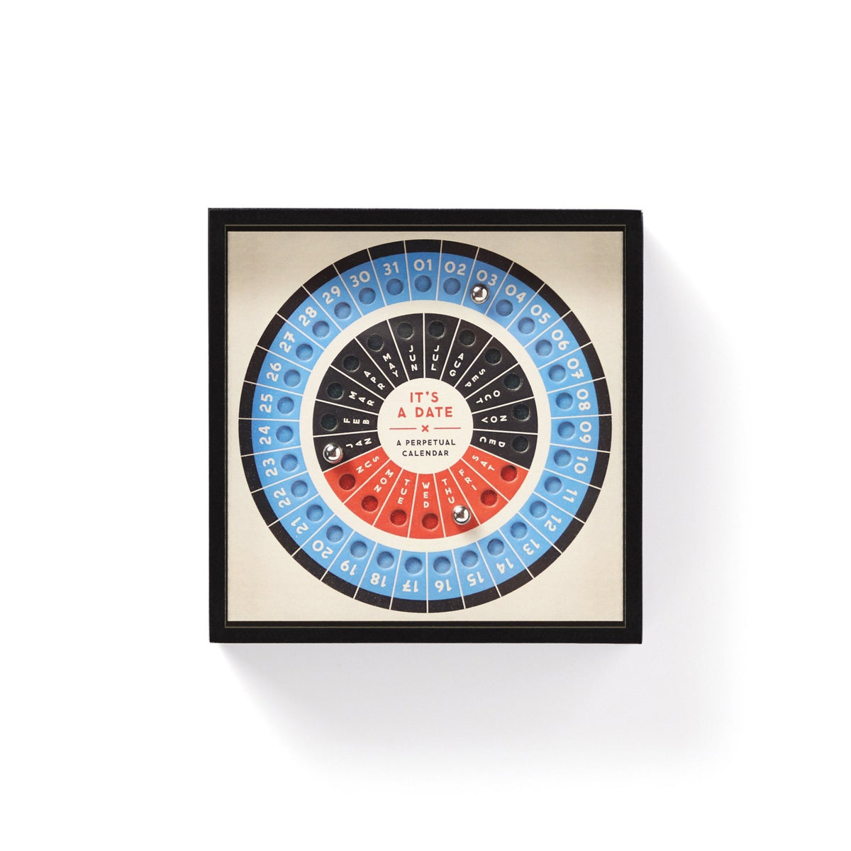 Brass Monkey’s Its A Date Perpetual Desk Calendar features concentric circular rows of numbers and colors on a cream background, labeled “ITS A DATE,” with blue, black, and red segments for a puzzle-like look.
