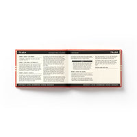An open book from Brass Monkey’s “It’s In The Cards Playing Card Game Set” displays instructions for Trash, with black and white text, bold headings, a red border, and sections on materials, gameplay steps, winning tips, and notes—ideal for card players.
