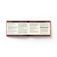 An open book from Brass Monkey’s “It’s In The Cards Playing Card Game Set” shows how to play games like Spoons and Euchre, covering required items, goals, rules, scoring, and difficulty levels for card players.