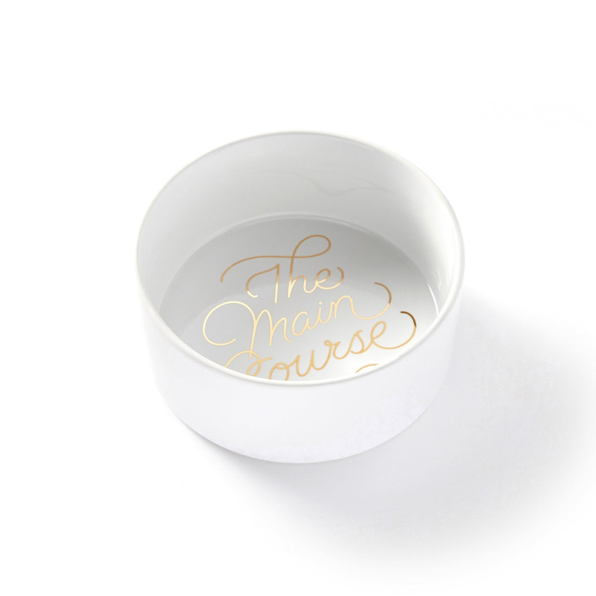 The Brass Monkey Main Course Pet Food Bowl is a durable ceramic bowl with reflective gold The Main Course lettering at the bottom, shown against a plain white background.
