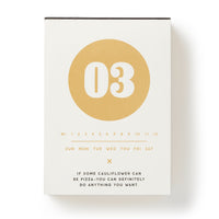 The Brass Monkey Make My Day Undated Desk Calendar features a vintage-inspired design with a bold gold “03,” daily dates, and affirmations like “IF SOME CAULIFLOWER CAN BE PIZZA—YOU CAN DEFINITELY DO ANYTHING YOU WANT.”.