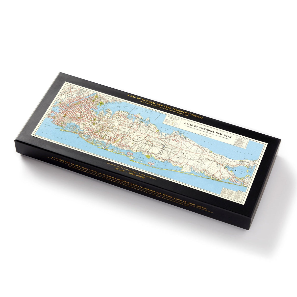 The Brass Monkey NYC Map 1,000 Piece Panoramic Puzzle comes in a rectangular black box with a colorful vintage map of Long Island, New York on the lid and yellow text along the edges—perfect for puzzle lovers.