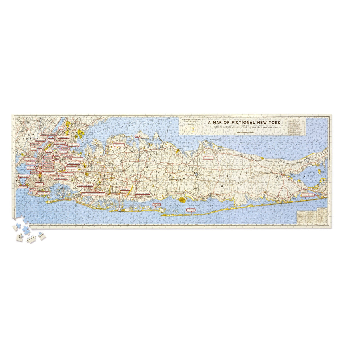 The Brass Monkey NYC Map 1,000 Piece Panoramic Puzzle features a vintage-style map of New York with fictional place names from movies, TV, and books, plus puzzle pieces and nods to famous NYC landmarks.