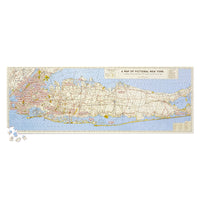The Brass Monkey NYC Map 1,000 Piece Panoramic Puzzle features a vintage-style map of New York with fictional place names from movies, TV, and books, plus puzzle pieces and nods to famous NYC landmarks.