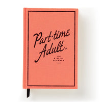 The Brass Monkey Part-Time Adult Undated Daily Planner features a coral cover with Part-time Adult. A Daily Planner in black cursive and print, plus a black border and ribbon bookmark.