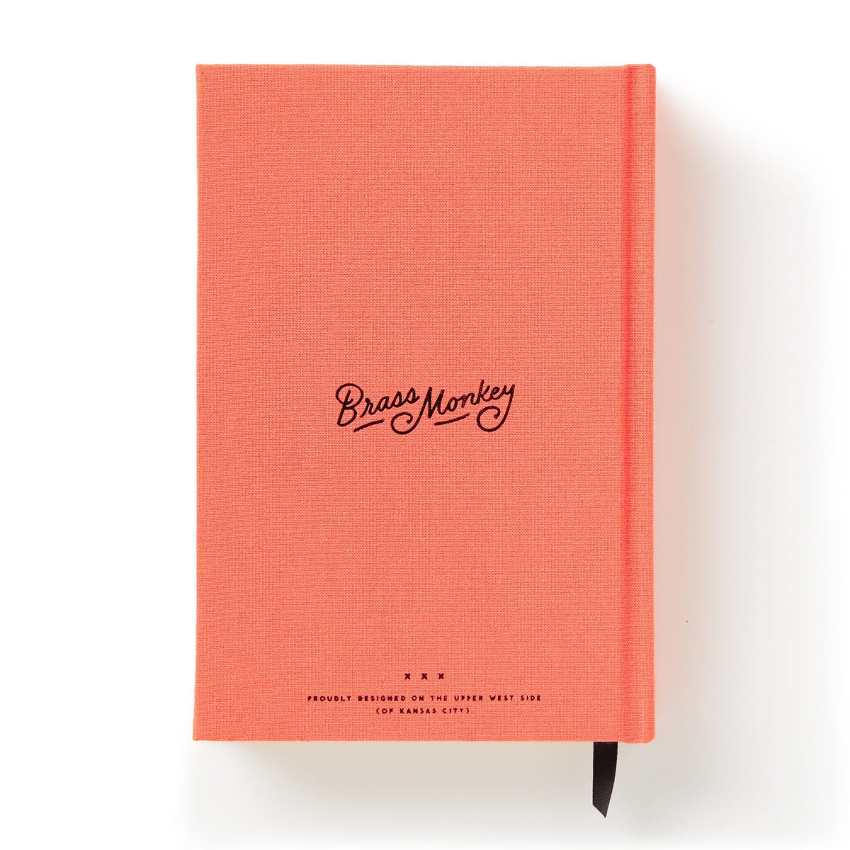 A coral pink hardcover Part-Time Adult Undated Daily Planner by Brass Monkey features black cursive branding and small text on the cover, plus a black ribbon bookmark. The planner is shown against a white background.