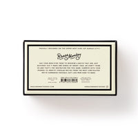 A box labeled in cream with the Brass Monkey logo and playful text introduces the “Poorly Explained Movies Game”—a party game with convoluted movie summaries—plus a barcode and website at the bottom.