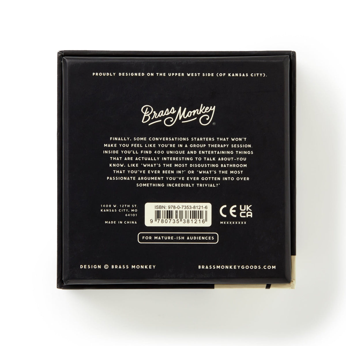 The back of the black Brass Monkey Question Sparks box displays product info, a barcode, witty text about fun question cards, plus the Brass Monkey logo, address, ISBN, and certification logos.