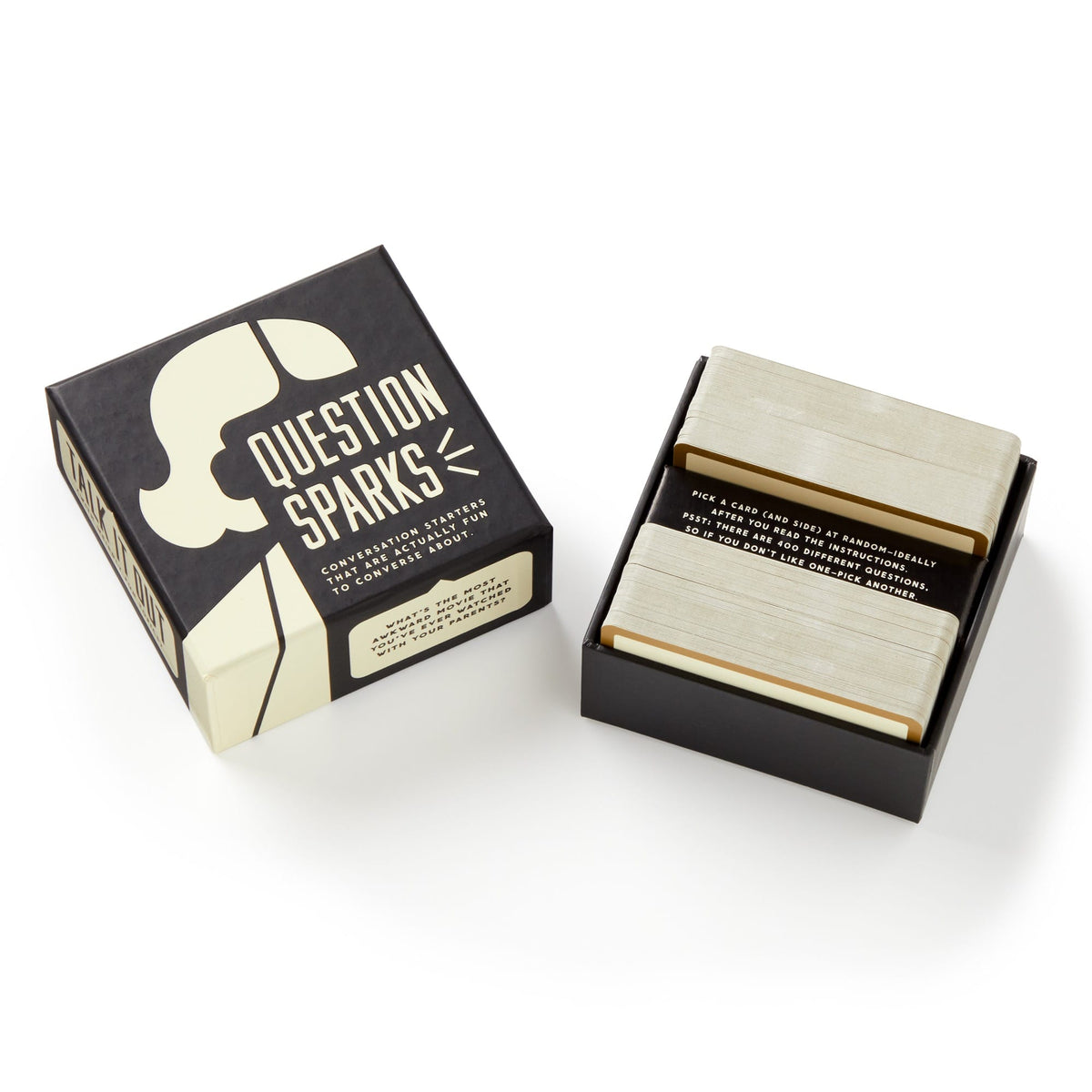 A box of Brass Monkey’s Question Sparks sits open, showing two stacks of cards inside. Its bold black and cream graphics promise fun conversation starters and engaging topics for any group or gathering.