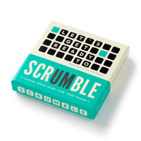 A box of Brass Monkeys Scrumble Magnetic Fridge Game with teal and cream packaging. The lid features magnetic tiles spelling LETS GET READY TO SCRUMBLE, and describes it as a casual crossword-style fridge magnet game.