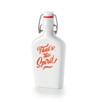 The Thats The Spirit Porcelain Flask by Brass Monkey is a vintage-inspired white porcelain flask with a swing-top lid, red seal, and bold orange Thats the Spirit script on the front.
