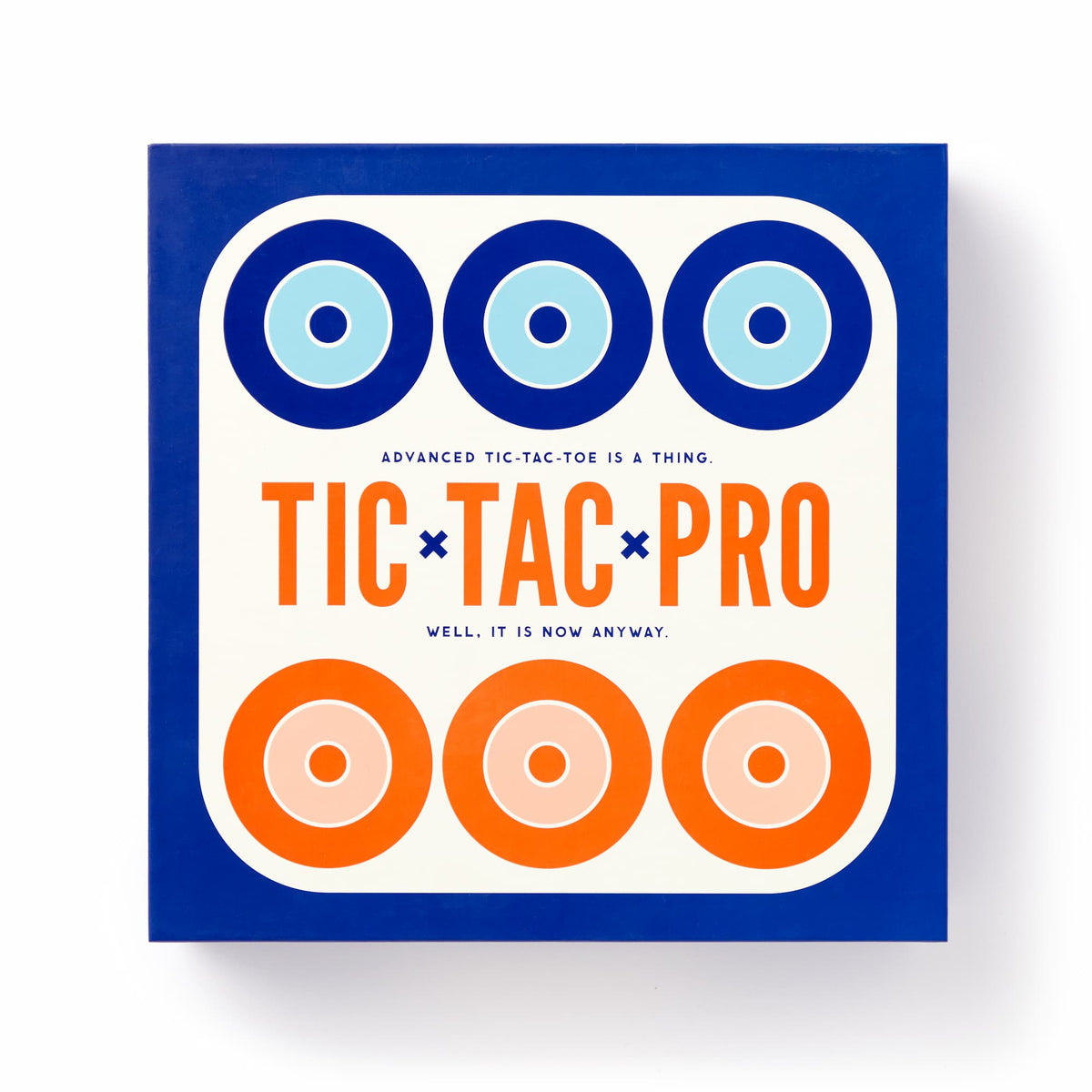 The Brass Monkey Tic Tac Pro Game Set comes in a square box with blue and orange concentric circles on white, featuring painted wood pieces for an advanced version of tic-tac-toe. The subtitle reads: “Advanced tic-tac-toe is a thing. Well, it is now anyway.”.