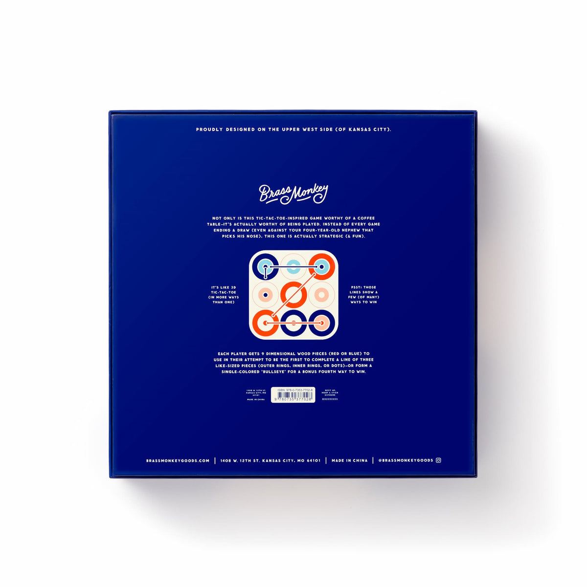 The back of the blue Tic Tac Pro Game Set box features the Brass Monkey logo at the top, a description, an image of a wooden advanced tic-tac-toe board with painted pieces in the center, and contact info at the bottom.