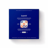 The back of the blue Tic Tac Pro Game Set box features the Brass Monkey logo at the top, a description, an image of a wooden advanced tic-tac-toe board with painted pieces in the center, and contact info at the bottom.