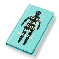 The Brass Monkey To Be Read Upon My Death Journal features a turquoise cover with a playful black silhouette and Xs for eyes, plus subtext: (a do-it-yourself memoir with life-story prompts).